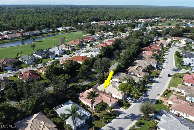 an aerial view of a house with a swimming pool yard and outdoor seating