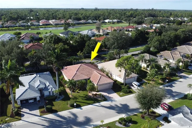 an aerial view of house with yard swimming pool and outdoor seating