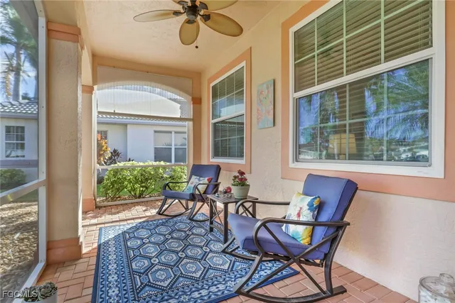 a balcony with table and chairs
