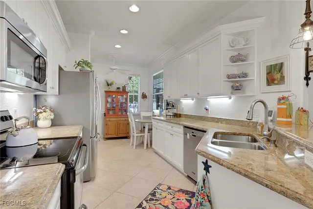 a kitchen with a sink appliances and cabinets