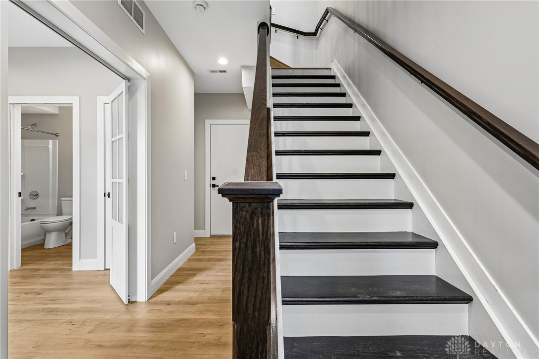 3906 Edwards Road, Unit C Cincinnati, OH 45209 - Photo 5 of 46 Elegant staircase with rich wood accents complements modern flooring and offers access to well-appointed spaces.