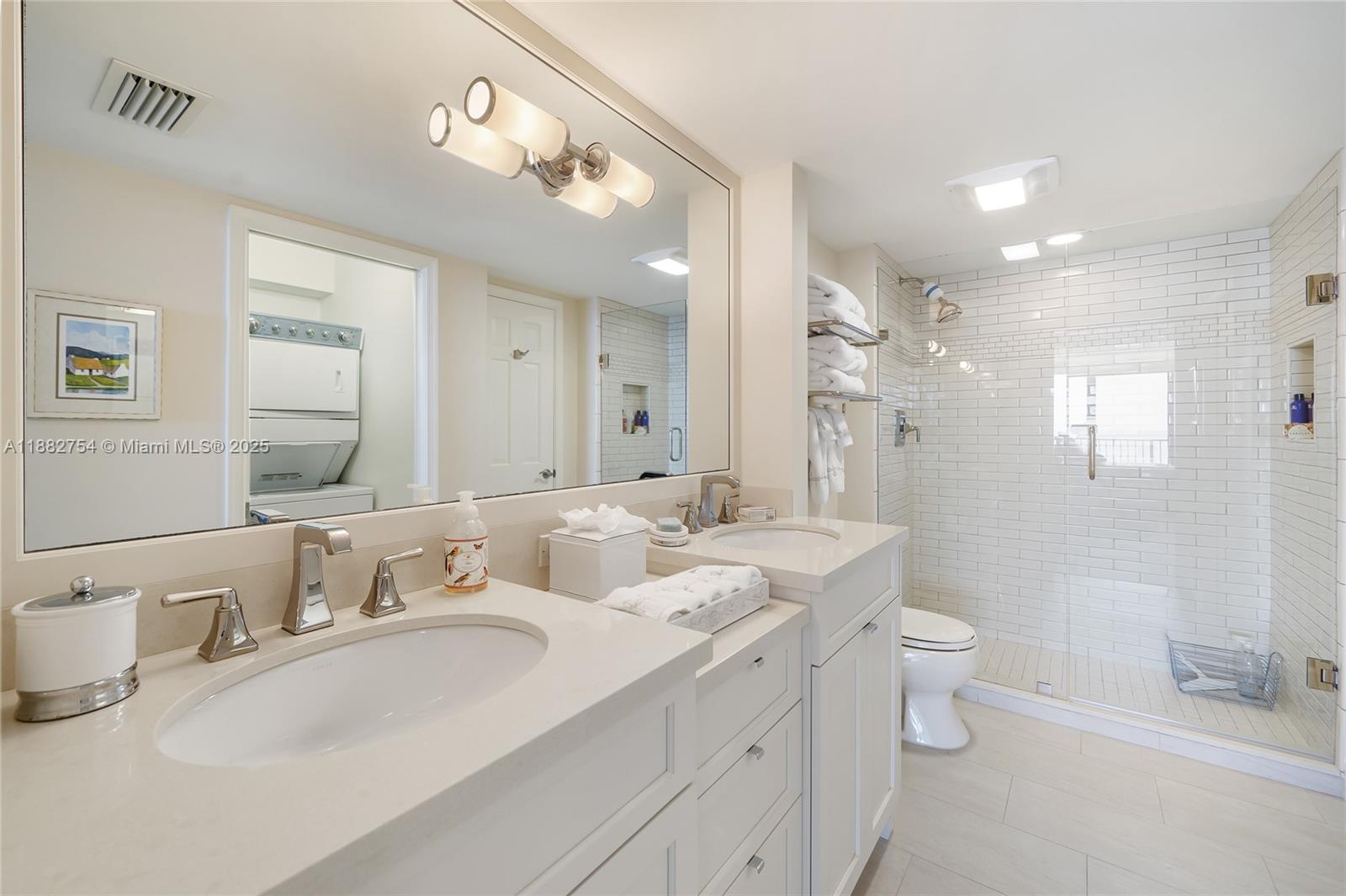 200 South Beach Road, Unit 202 Tequesta, FL 33469 - Photo 20 of 45 a bathroom with a double vanity sink mirror double and toilet