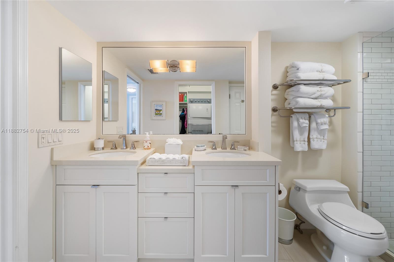 200 South Beach Road, Unit 202 Tequesta, FL 33469 - Photo 21 of 45 a bathroom with a sink a toilet and mirror