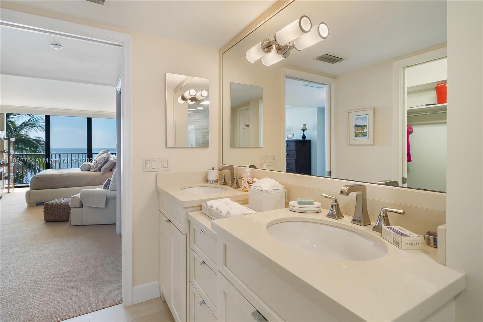 200 South Beach Road, Unit 202 Tequesta, FL 33469 - Photo 23 of 45 a en suite bathroom with a double vanity sink and a mirror
