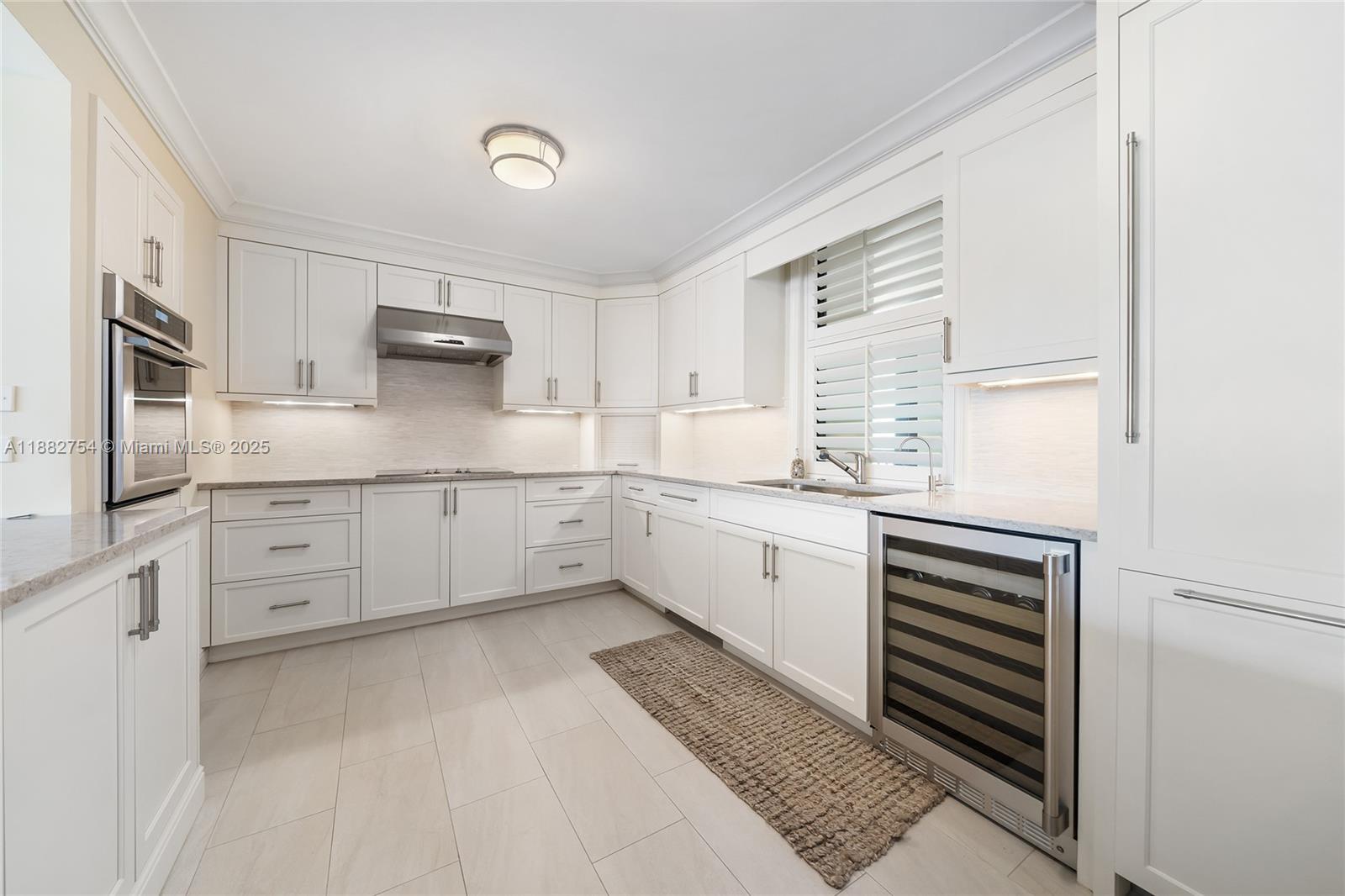 200 South Beach Road, Unit 202 Tequesta, FL 33469 - Photo 6 of 45 a kitchen with granite countertop white cabinets and white appliances
