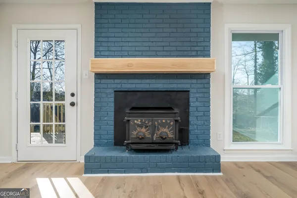 a living room with a fireplace and windows