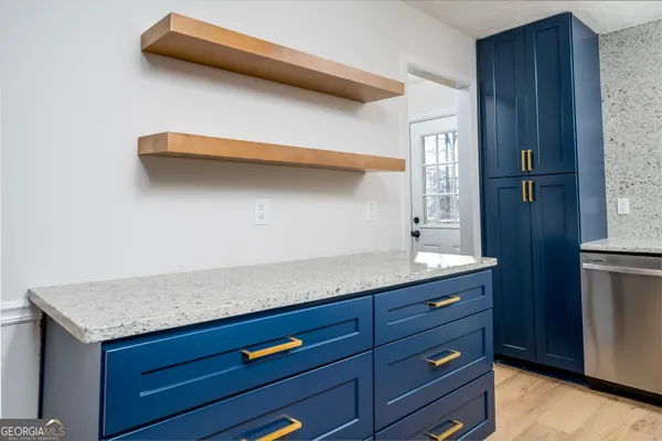 a kitchen with a sink a refrigerator and cabinets