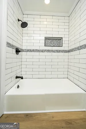 a bathroom with a bathtub and shower