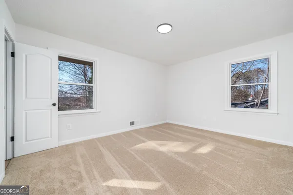 a view of a big room with windows and closet
