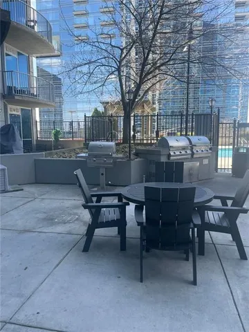 a view of a patio with table and chairs under an umbrella