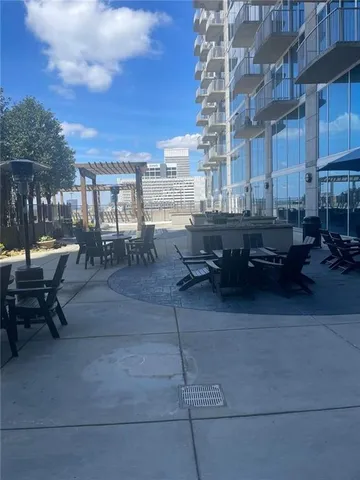 a view of a patio with dining table and chairs