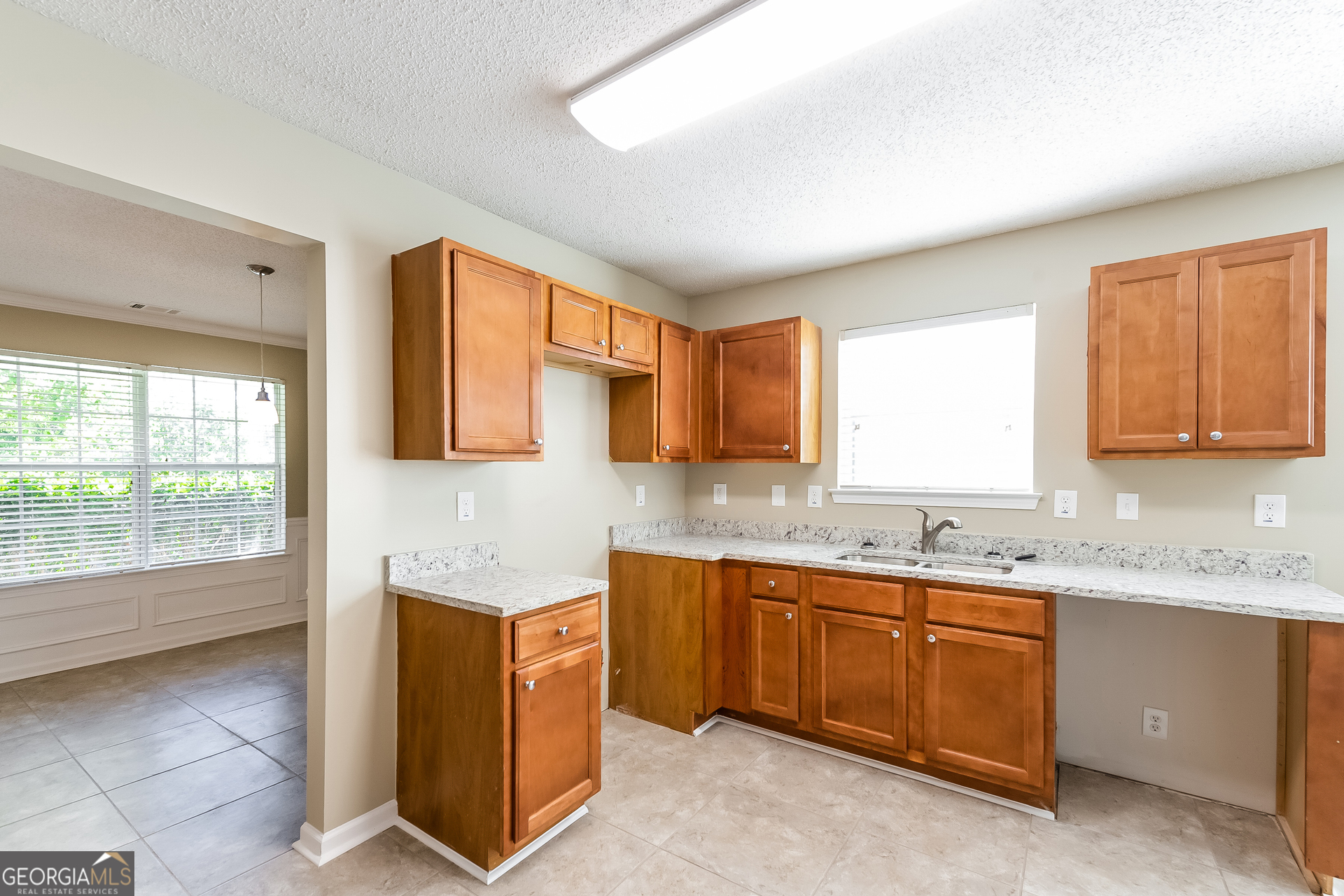 6998 ⛉ Bonnes Boulevard Austell, GA 30168 - Photo 6 of 15 a kitchen with a sink stove and cabinets