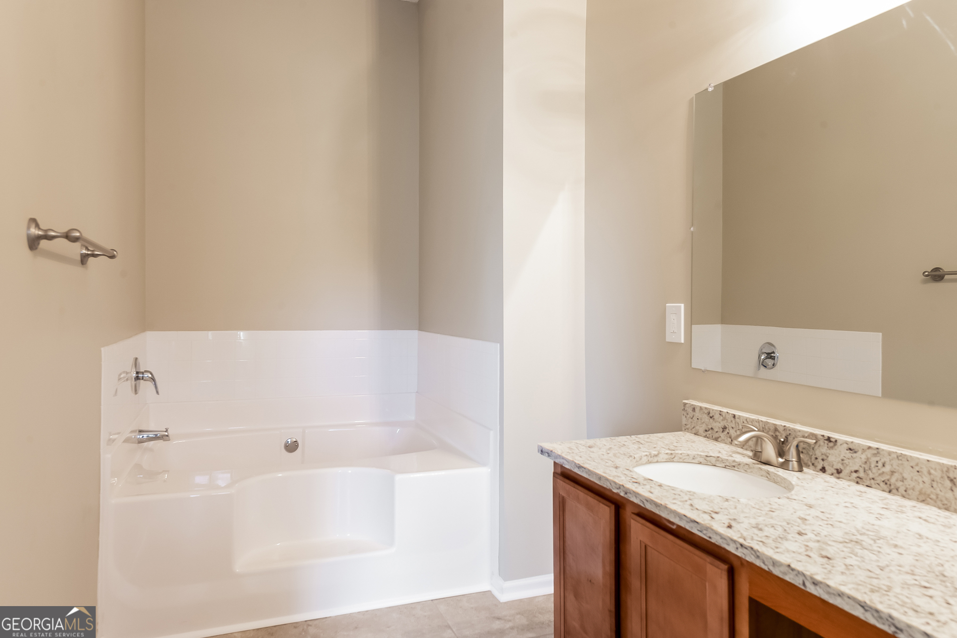 6998 ⛉ Bonnes Boulevard Austell, GA 30168 - Photo 9 of 15 a bathroom with a granite countertop sink and a bathtub