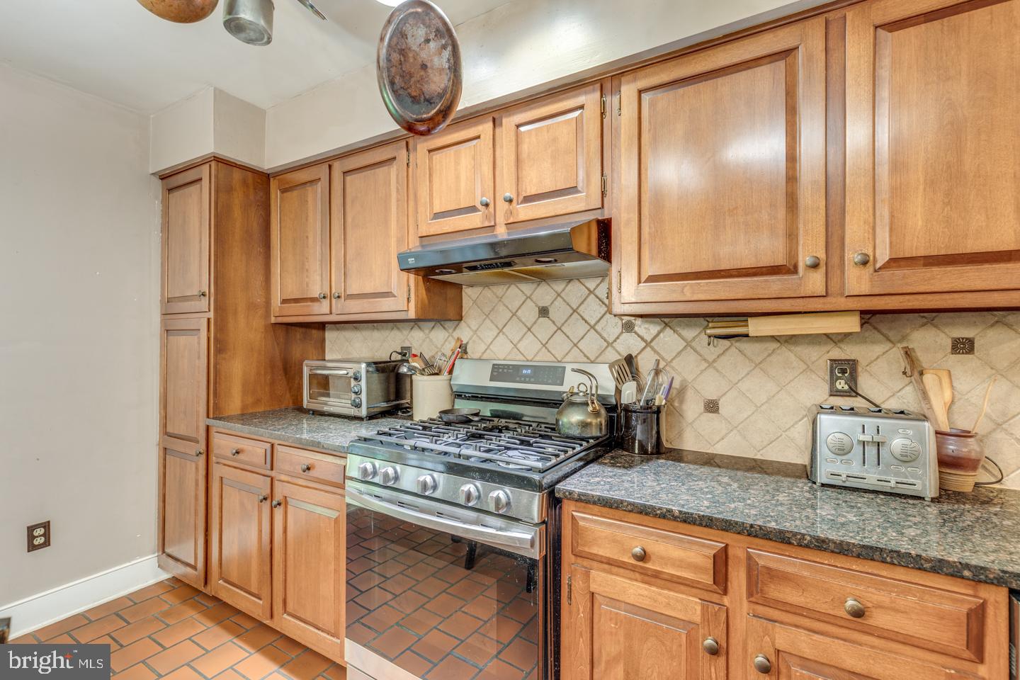 15 East 2nd Street Moorestown, NJ 08057 - Photo 12 of 52 a kitchen with granite countertop a sink a stove and cabinets