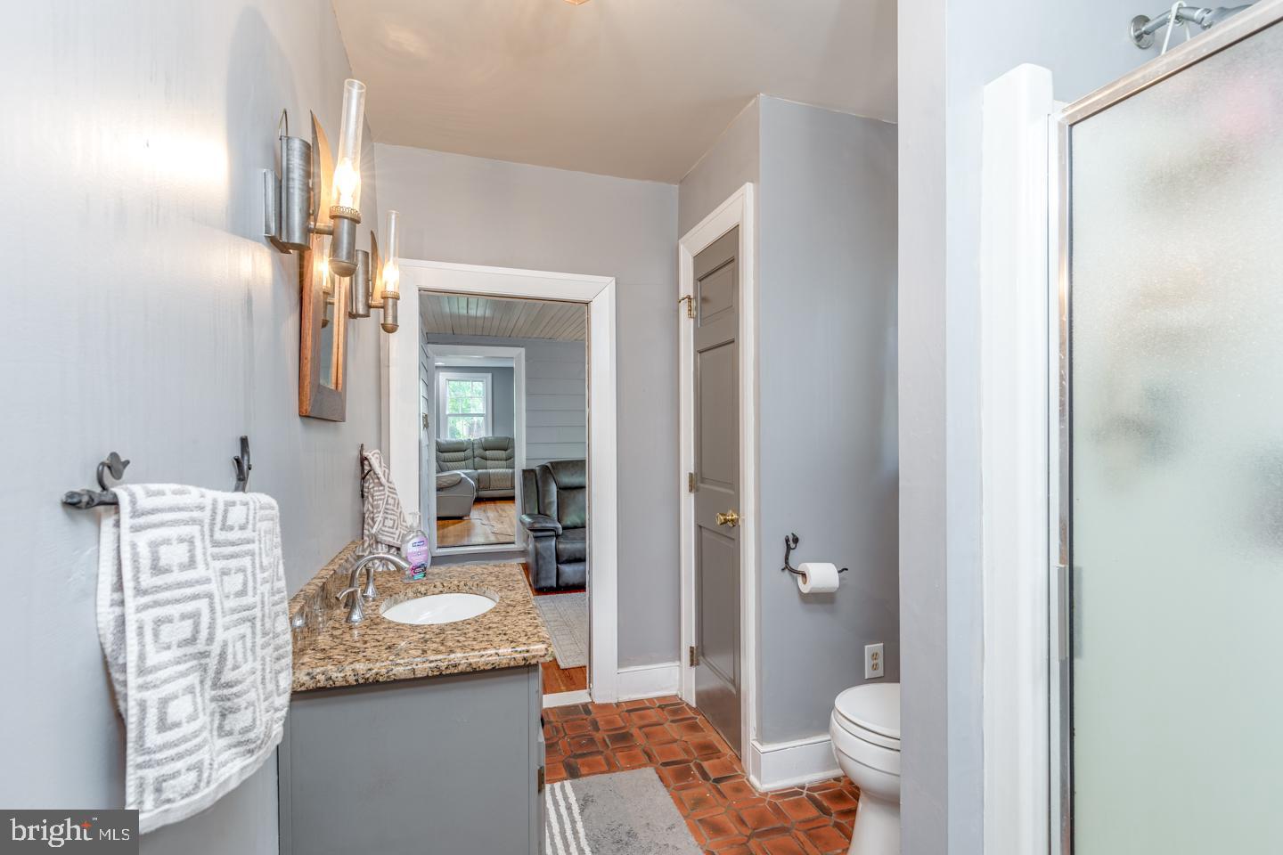 15 East 2nd Street Moorestown, NJ 08057 - Photo 13 of 52 a bathroom with a granite countertop sink and a mirror