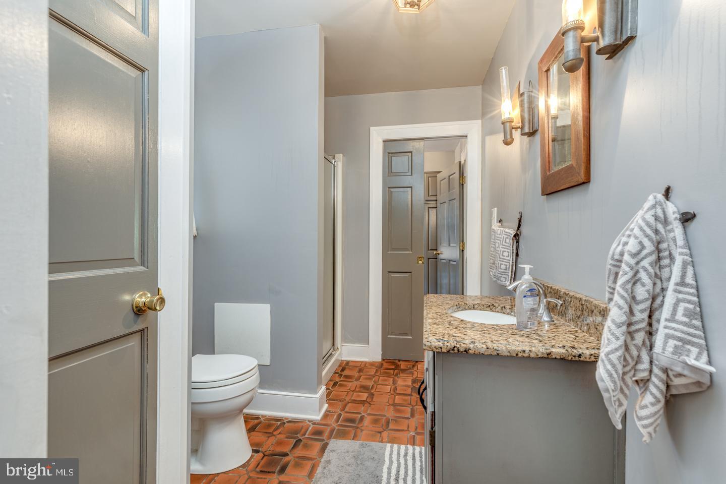 15 East 2nd Street Moorestown, NJ 08057 - Photo 30 of 52 a bathroom with a granite countertop sink toilet and shower