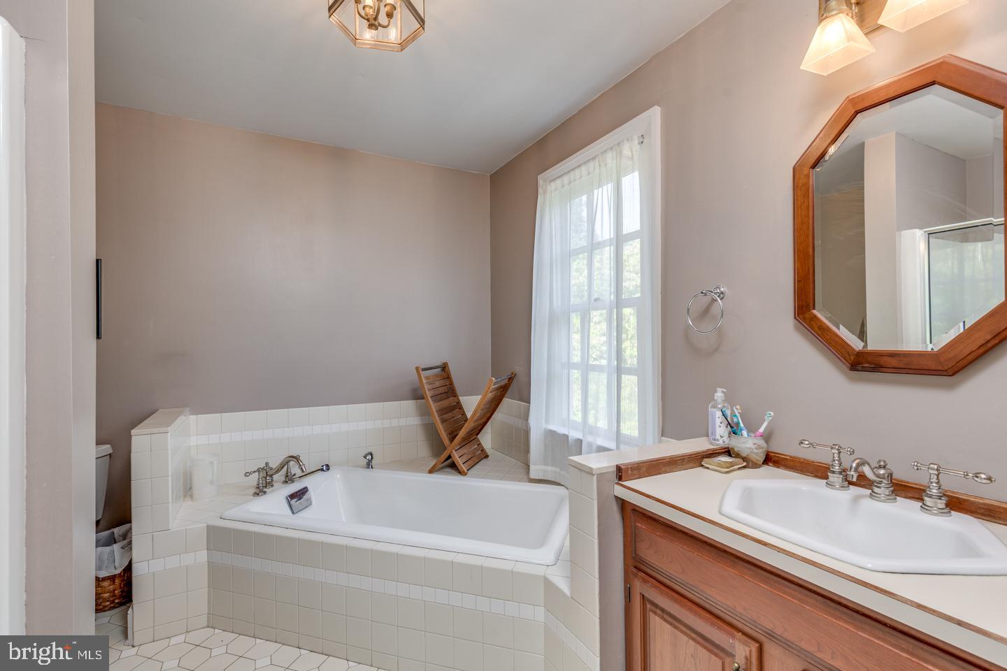 15 East 2nd Street Moorestown, NJ 08057 - Photo 39 of 52 a bathroom with a sink mirror and a bathtub