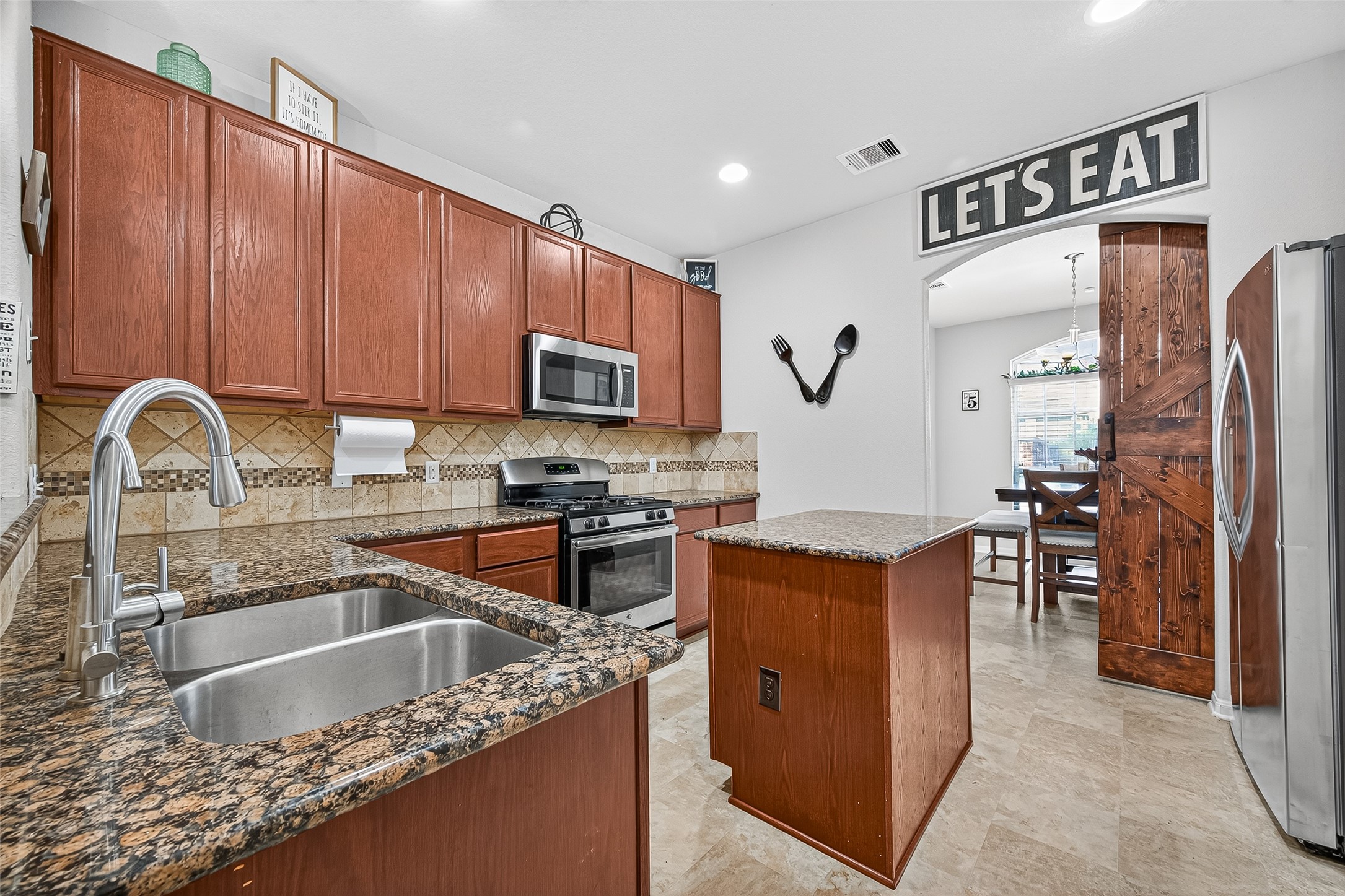 2611 Cottage Step Trail Fresno, TX 77545 - Photo 12 of 48 a kitchen with stainless steel appliances granite countertop a sink stove and refrigerator