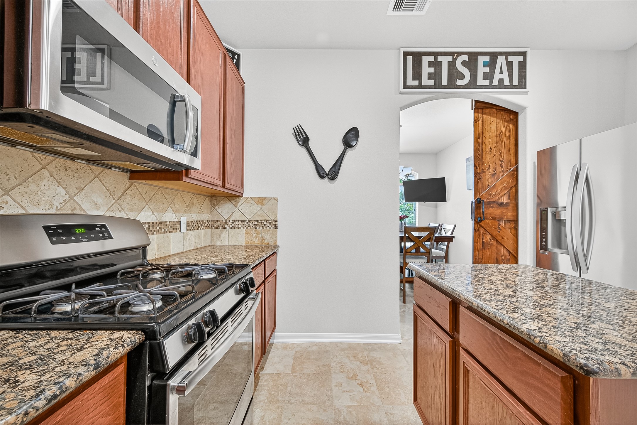 2611 Cottage Step Trail Fresno, TX 77545 - Photo 14 of 48 a kitchen with stainless steel appliances granite countertop a stove and a sink
