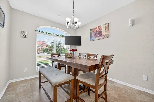 a view of a dining room with furniture and a chandelier