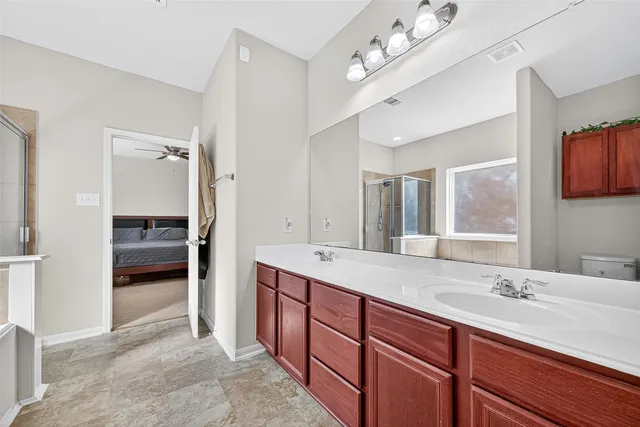 a bathroom with a sink double vanity and a shower