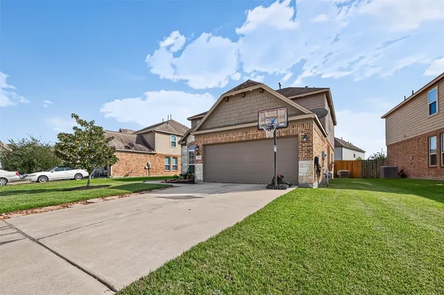 a front view of a house with a yard and garage