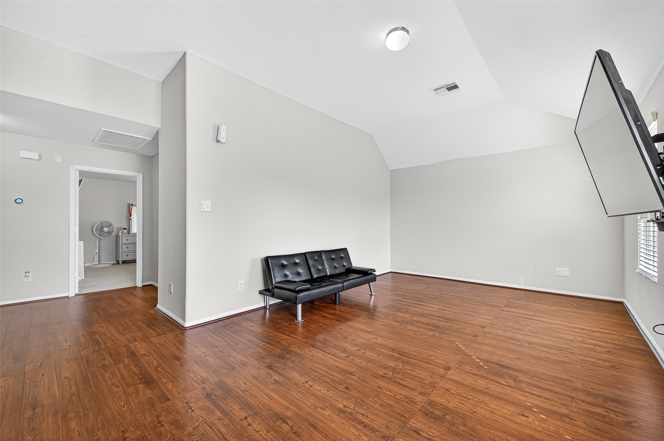2611 Cottage Step Trail Fresno, TX 77545 - Photo 32 of 48 a view of an empty room with wooden floor and a way to kitchen