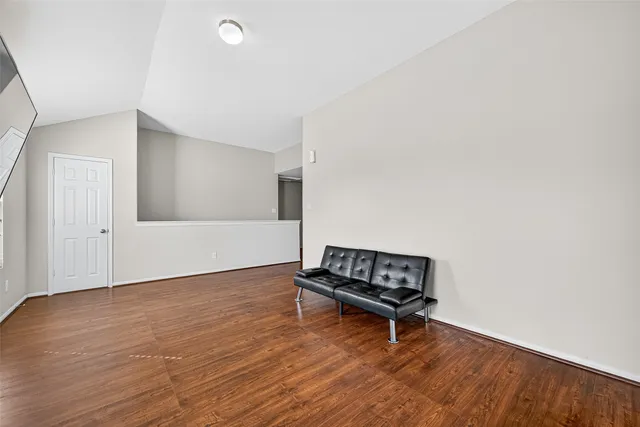 a living room with hard wood floors and a couch