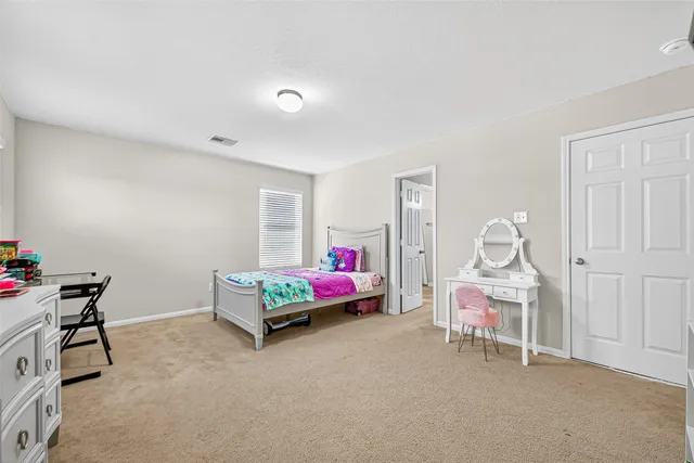 a bedroom with furniture and a ceiling fan