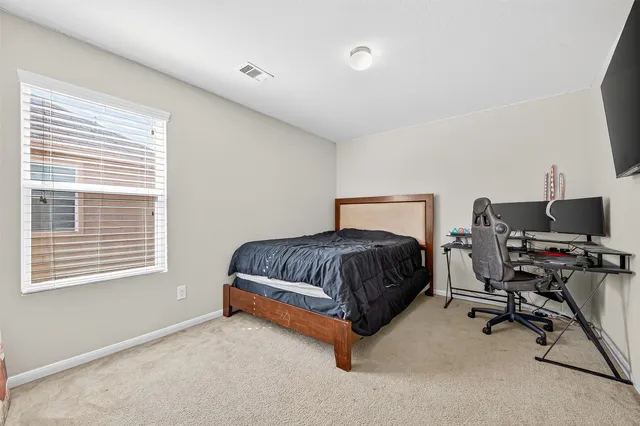 a bedroom with a bed and a chair