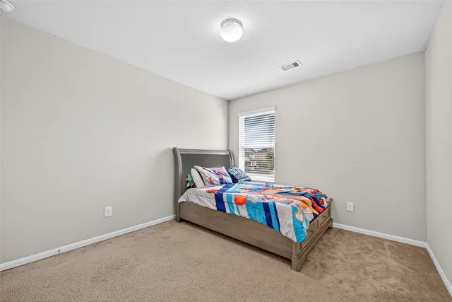 a bedroom with a bed and window