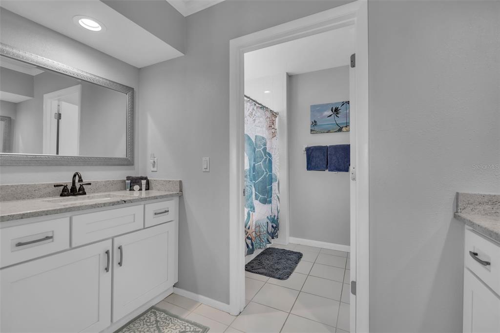 848 Evergreen Way Longboat Key, FL 34228 - Photo 18 of 66 a bathroom with a sink and a mirror