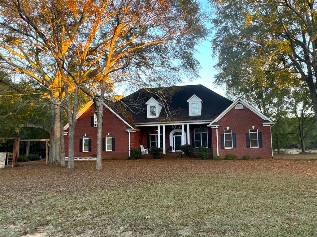 455 Pleasant Valley Road Northeast Monroe, GA 30655 - Photo 1 of 1 a front view of a house with a garden and trees