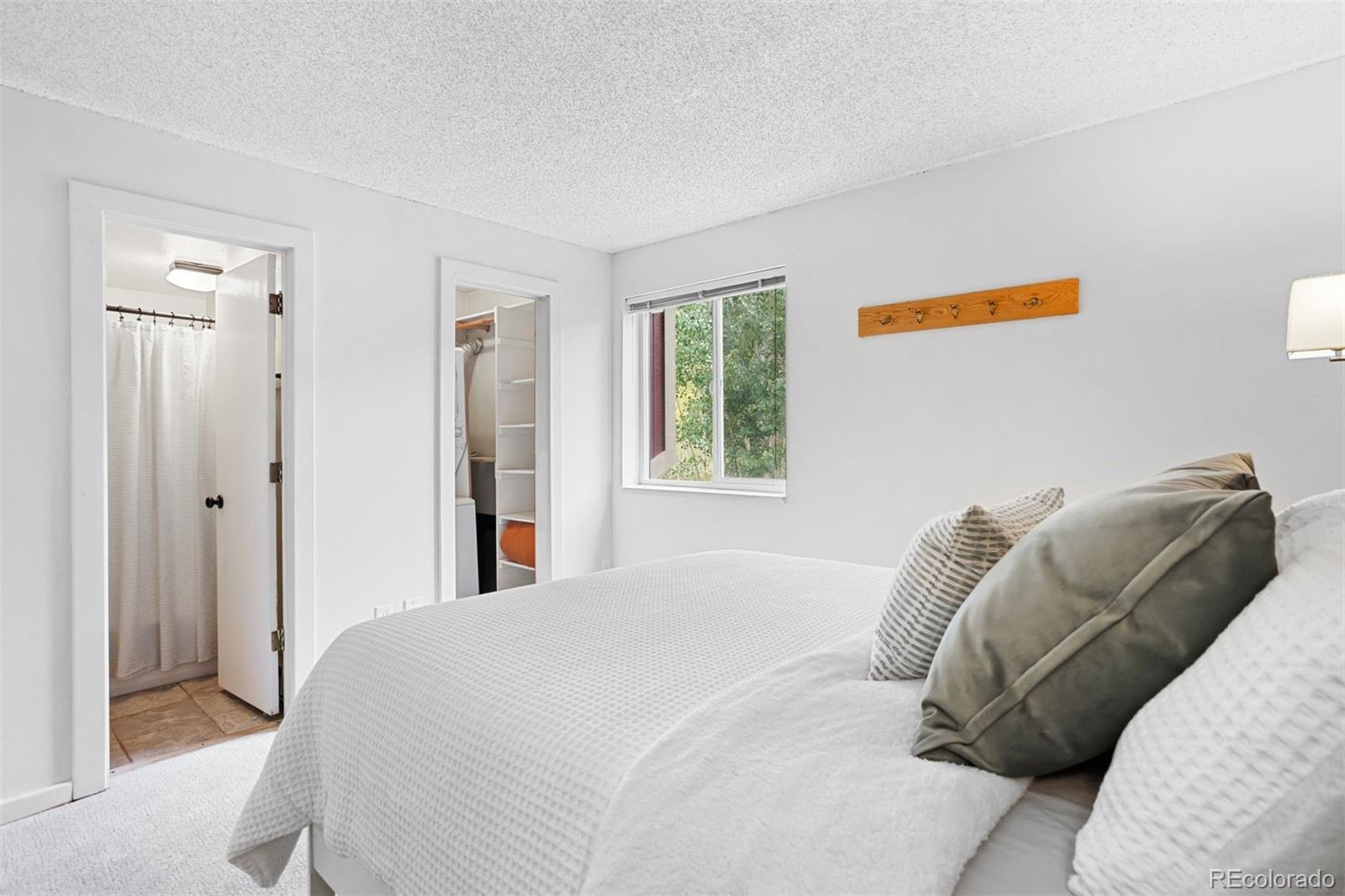 76 E Meadow, Unit 2 Fraser, CO 80442 - Photo 16 of 23 a bedroom with a bed and a window