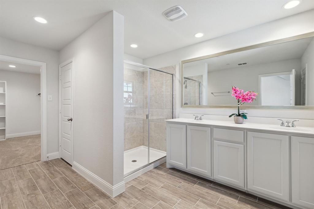 6028 Bursey Road Watauga, TX 76148 - Photo 21 of 27 a bathroom with a double vanity sink mirror and next to a window