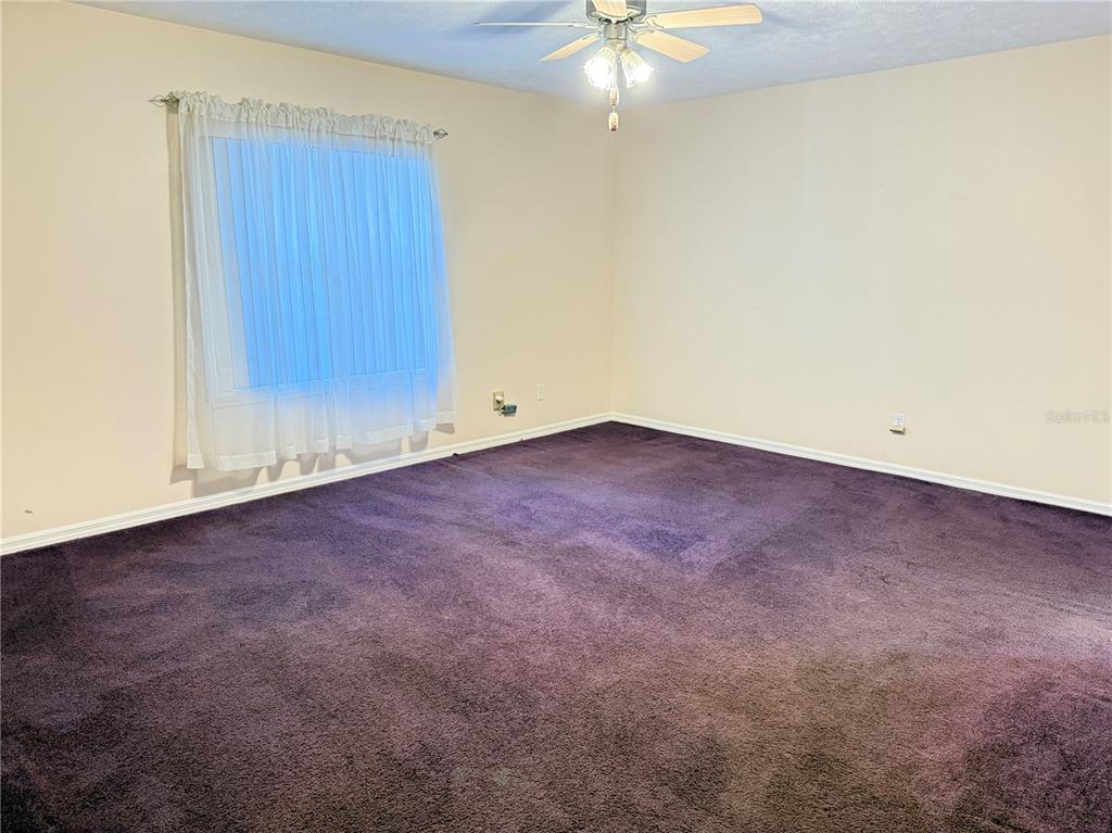 4262 Northeast 35th Avenue Road Ocala, FL 34479 - Photo 13 of 28 an empty room with a chandelier fan