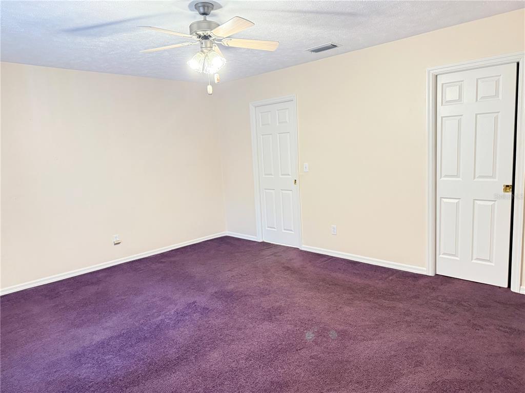 4262 Northeast 35th Avenue Road Ocala, FL 34479 - Photo 14 of 28 an empty room with a ceiling fan and a window