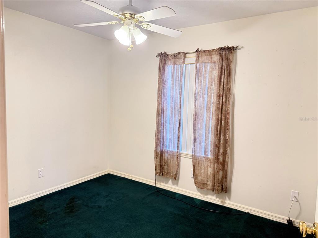 4262 Northeast 35th Avenue Road Ocala, FL 34479 - Photo 17 of 28 a view of a room with wooden floor and fan