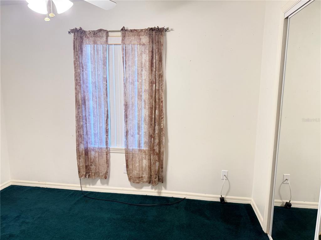 4262 Northeast 35th Avenue Road Ocala, FL 34479 - Photo 18 of 28 a view of a room with wooden floor and a window