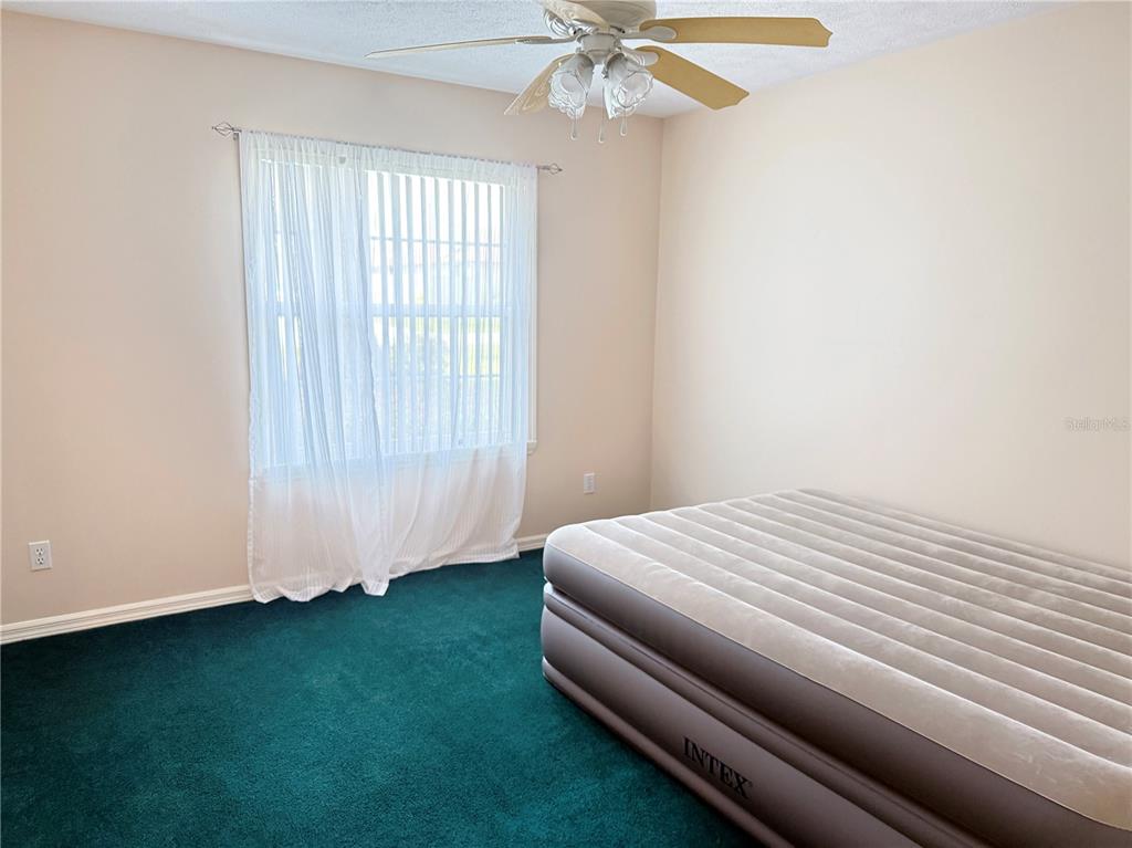 4262 Northeast 35th Avenue Road Ocala, FL 34479 - Photo 21 of 28 a bedroom with a bed and a chandelier