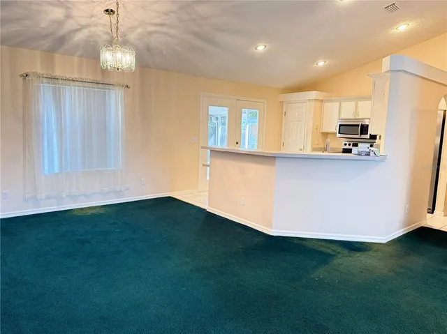 a kitchen with stainless steel appliances a refrigerator a stove top oven a sink and dishwasher with wooden floor