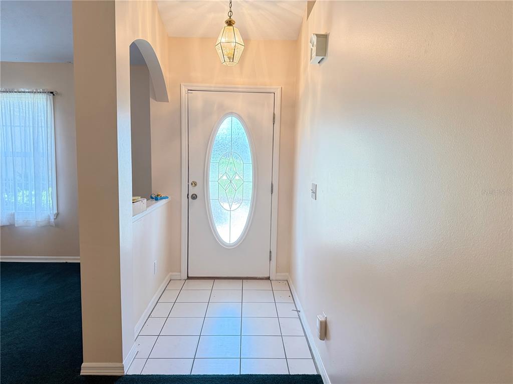 4262 Northeast 35th Avenue Road Ocala, FL 34479 - Photo 6 of 28 an entryway view with wooden floor and glass door