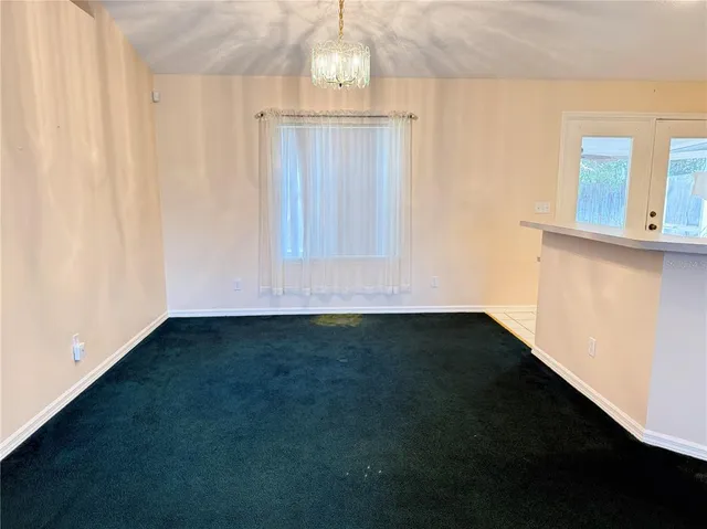a view of a kitchen with wooden floor and a window