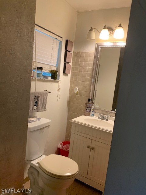 2307 Unity Avenue Fort Myers, FL 33901 - Photo 5 of 25 a bathroom with a toilet sink vanity and mirror