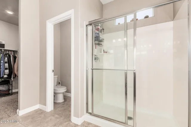 a view of walk in closet with clothes