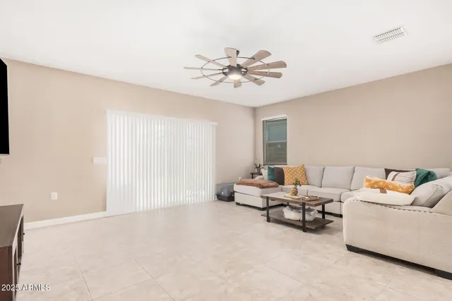 a living room with furniture and kitchen view