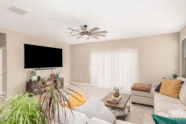 a dining hall with stainless steel appliances kitchen island granite countertop a table and chairs