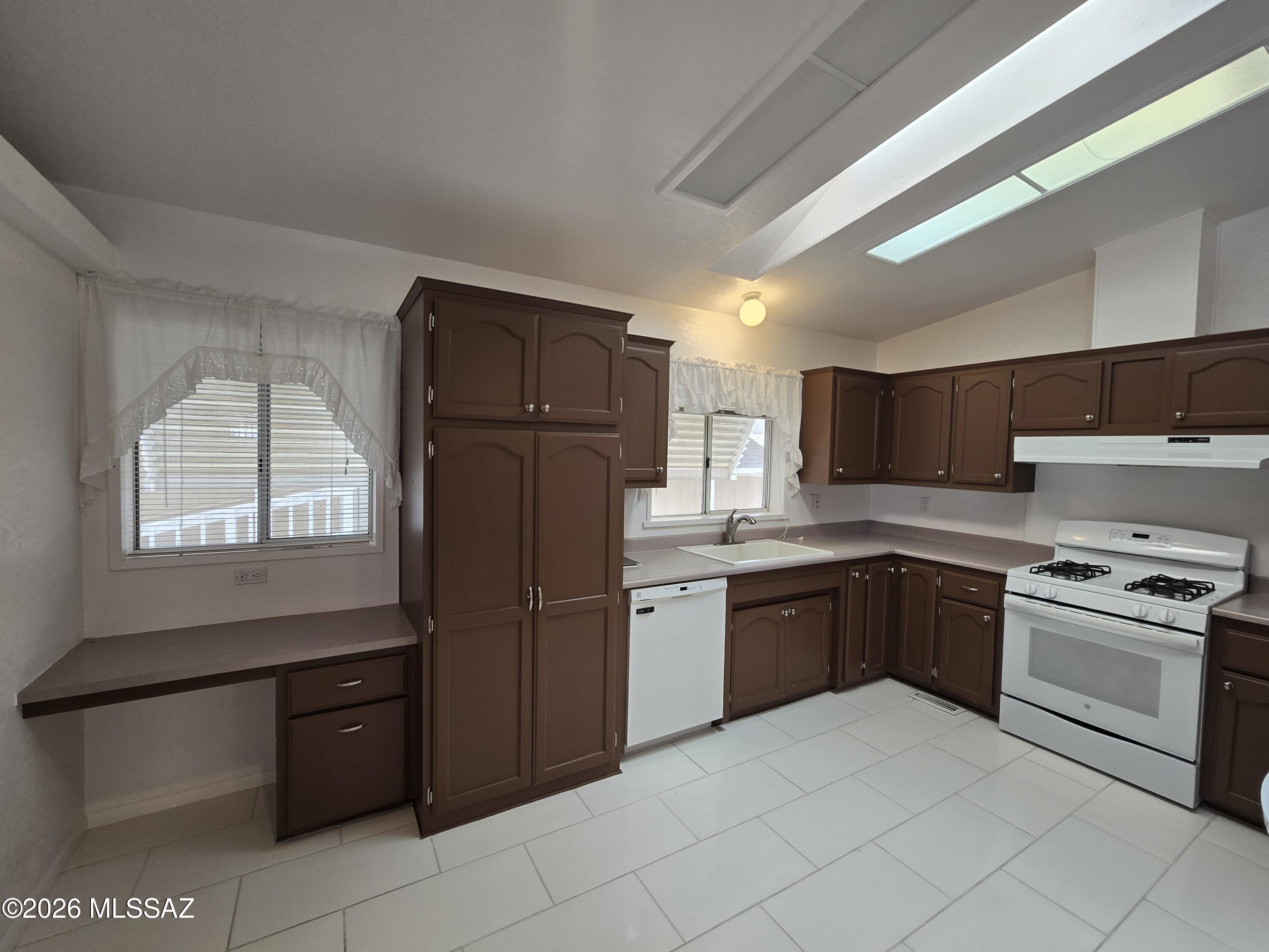 8401 South Kolb Road, Unit 61 Tucson, AZ 85756 - Photo 12 of 23 a kitchen with stainless steel appliances granite countertop a refrigerator and wooden cabinets
