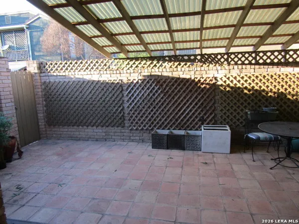 a view of a chairs and table in the patio