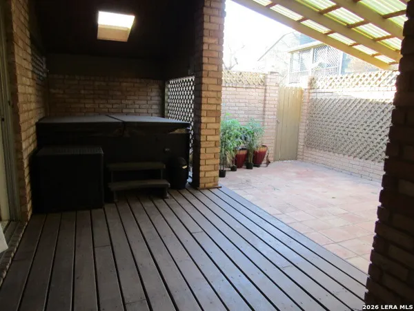 a backyard of a house with barbeque oven table and chairs